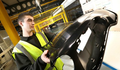 Jamie Wheeler, Production Operative at Omega Plastics with a component produced using the 1,300-tonne machinery.