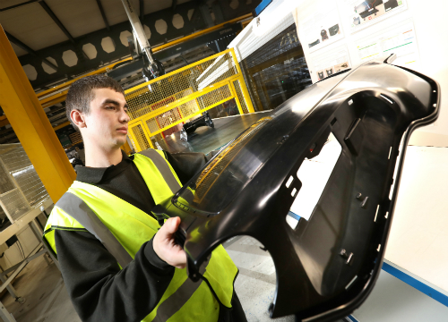 Jamie Wheeler, Production Operative at Omega Plastics with a component produced using the 1,300-tonne machinery.