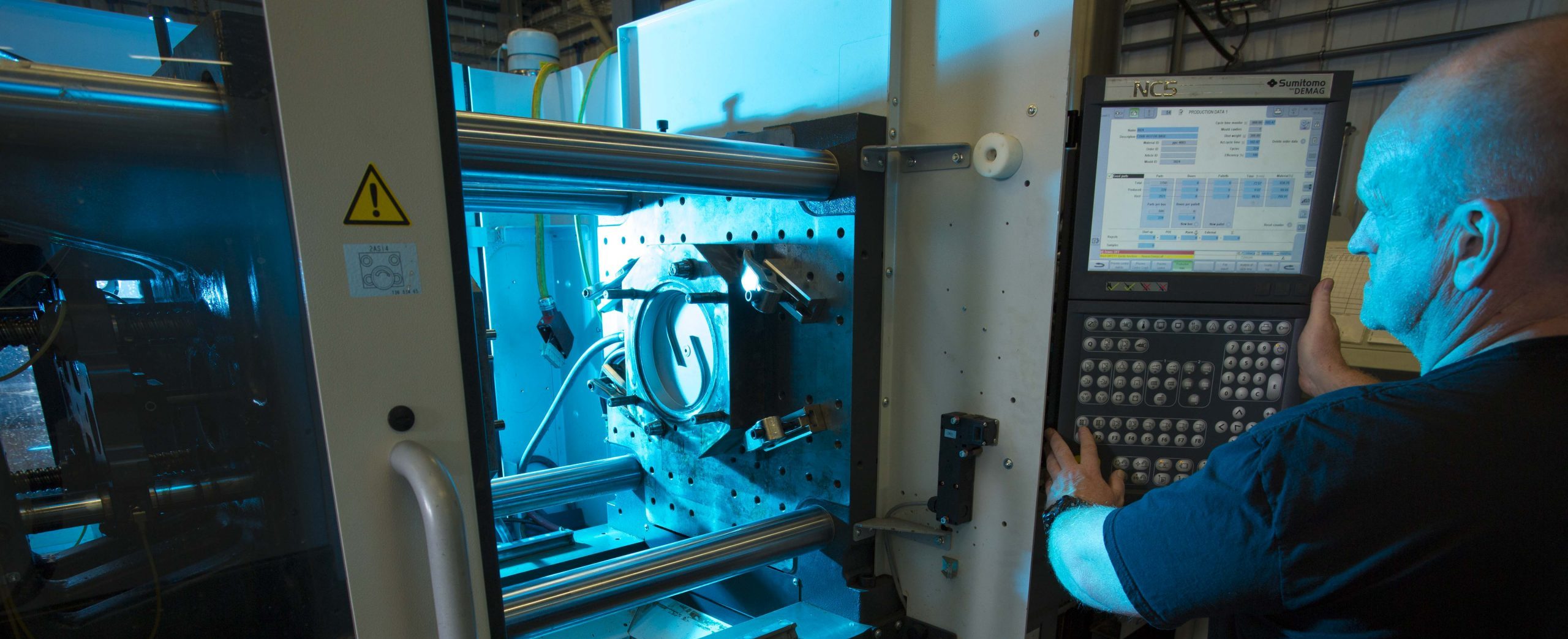 Colleague looks inside a moulding machine