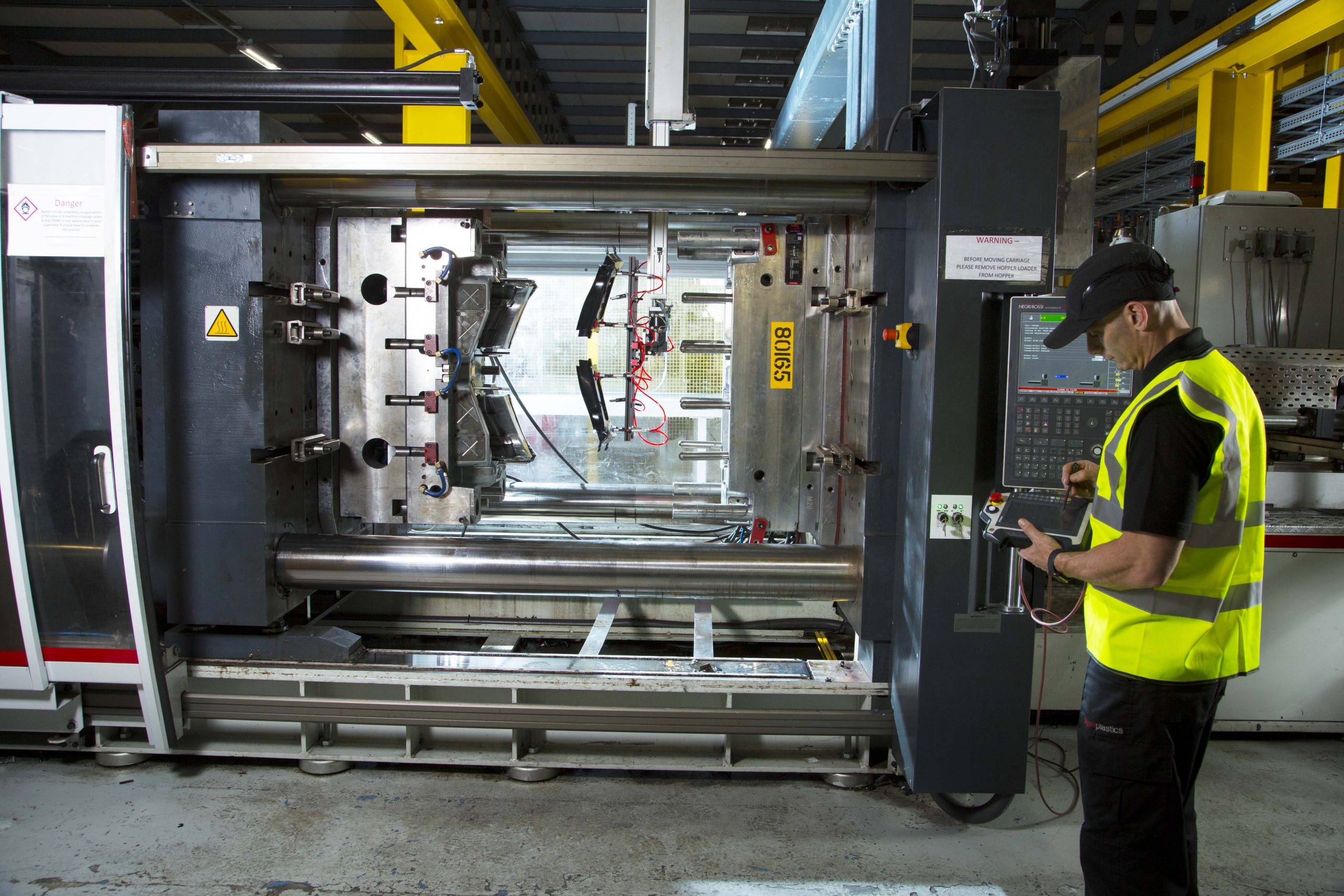 Colleague maintaining a moulding machine